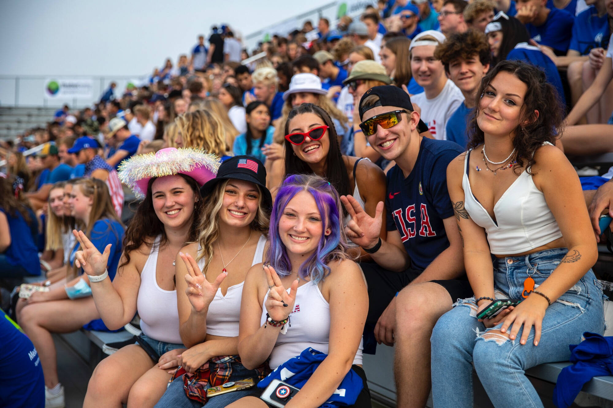 students sitting together at a football game